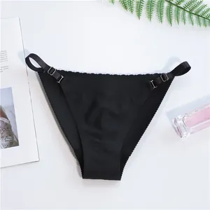 Seamless black thong with adjustable side straps and wave-cut edges for women's comfort.