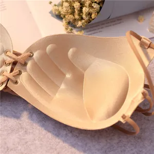Beige strapless push-up bra with a lace-up front design and palm-shaped padding detail