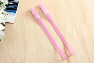 Detail view of 1.0cm pink silicone non-slip invisible bra straps on wooden background