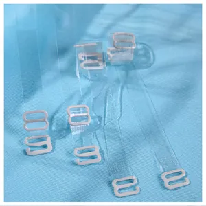 Adjustable invisible transparent bra straps with non-slip white plastic hooks on blue fabric