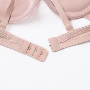 Pink seamless low back U-shaped bra detail featuring adjustable straps and hook-and-eye closure