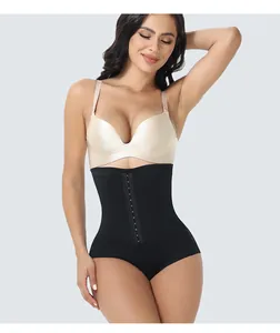 Professional studio shot of high-waisted black tummy control shapewear with front row buckles