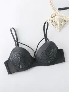 Close-up of charcoal grey floral lace bra showing intricate embroidery and straps