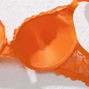Close-up detail of the breathable orange lace inner cup on this push-up bra.