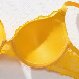 Detailed close-up showing the soft lace texture and vibrant yellow color of the push-up bra