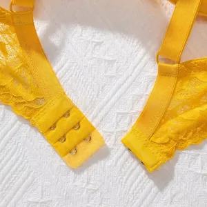 Macro view of the four-row hook and eye back closure on a breathable yellow lace bra