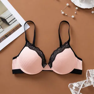 Detail of pink ribbed bra with elegant black lace trim and adjustable straps