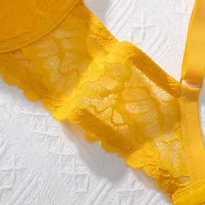 Close-up of yellow floral lace bra with breathable texture and adjustable strap.