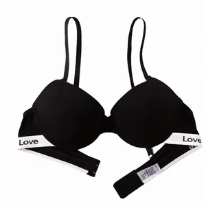 Minimalist black push-up bra with 'Love' lettered elastic band and smooth finish