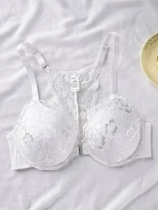 Close-up detail of white lace front-closure bra with racerback design