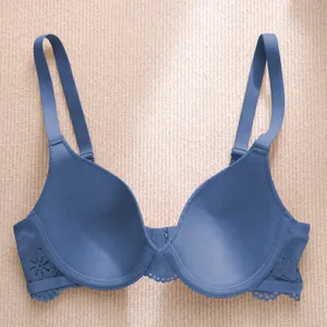 Comfortable blue push-up bra featuring elegant lace details on a beige background