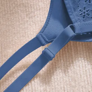 Close-up of blue lace push-up bra featuring adjustable straps and elegant floral patterns