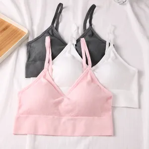 Set of three ribbed seamless sports bras in pink white and grey with U-back design