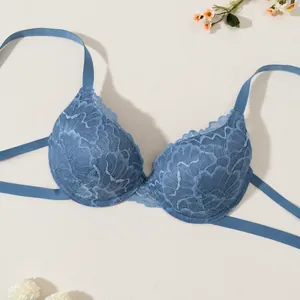 Reggiseno push-up sexy in pizzo blu con delicato motivo floreale su sfondo beige