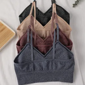 Set of four seamless V-neck yoga sports bras with removable pads in various earth tones