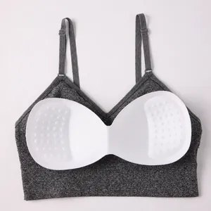 Heather grey yoga sports bra with removable white massage pads and adjustable straps