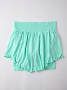 Close-up view of a mint green fake two-piece yoga skirt with ruffled hem and elastic waist