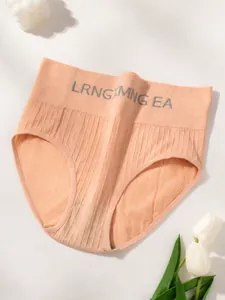 Close-up of apricot high-waisted ribbed panties with letter print and elastic band.