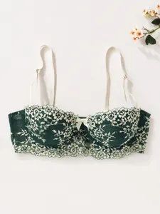 Elegant dark green lace bra featuring delicate white floral patterns and a cute bow detail