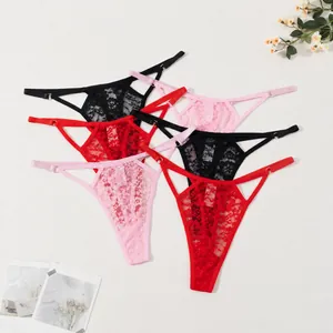 Detailed macro view of sexy floral lace thongs featuring hollow-out straps and golden rings