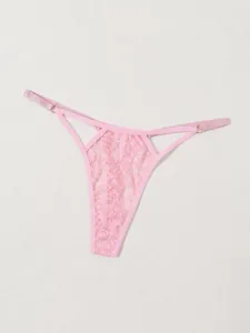 Close-up detail of pink floral lace thong with elegant hollow-out design and straps