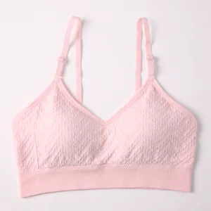 Comfortable pink seamless sports bra with adjustable straps and V-shaped textured pattern