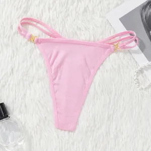 Close-up of pink ribbed thong with double straps and gold X-shaped hardware