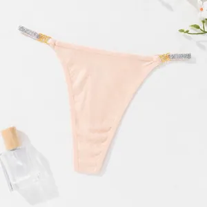 Sexy peach ribbed thong for women featuring sparkling rhinestone and metal strap details
