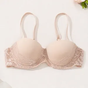 Detailed view of nude push-up bra with delicate lace trim and thin adjustable straps