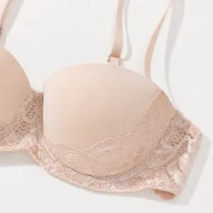 Close-up detail of sexy beige lace bra with supportive underwire design