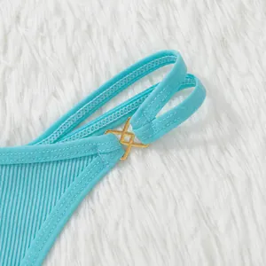 Light blue ribbed bikini bottom with gold metal link detail shown on white fur background