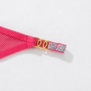 Detail of women's pink ribbed thong featuring gold metal rings and silver rhinestone strap.