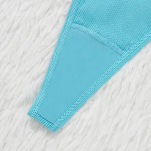 Macro view of light blue ribbed fabric thong underwear with detailed stitching