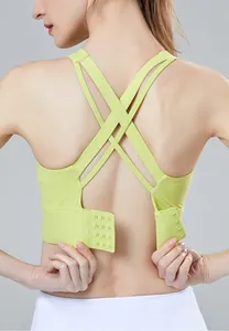 Detailed macro view of a lime green sports bra featuring cross-back straps and hook-and-eye closure.