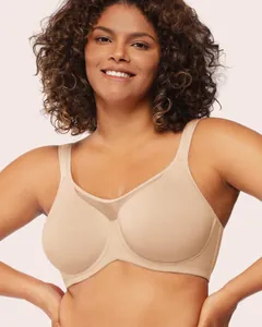 Detailed view of nude unlined underwired plus size bra on a smiling female model.