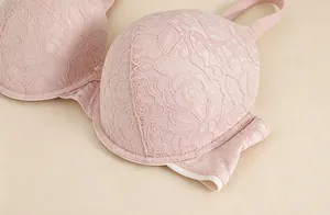 Macro shot of detailed floral lace patterns on a pink 3D molded push-up bra cup