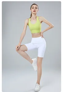 Detailed view of women's lime green high-elastic cross-back yoga bra and white shorts