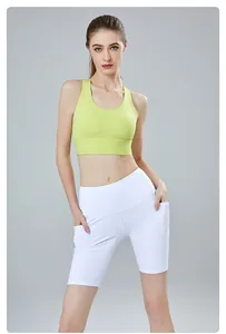 Front view of lime green sports bra and white yoga shorts with side pockets