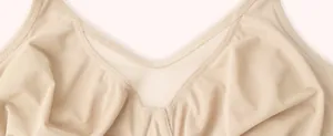 Detail of a beige plus size underwire bra showing soft fabric and mesh center