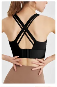 Detailed back view of a seamless black sports bra with a cross strap design and hook closure.