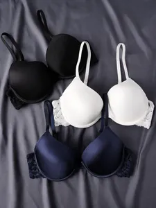 Set de tres sujetadores push-up de encaje en negro, blanco y azul marino con tirantes