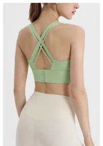 Back detail of a mint green cross-back sports bra featuring a secure hook-and-eye closure.