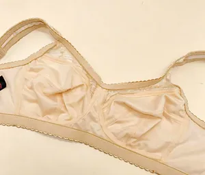 Detailed close-up showing the mesh interior and lace trim of this beige ultra-thin bra