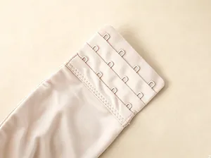 Detail view showing the 4-row hook-and-eye back closure of a beige wireless comfort bra