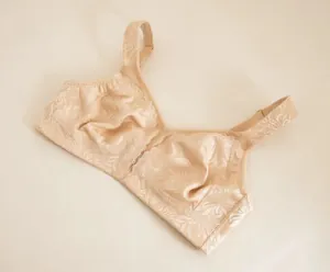 Detail view of the delicate lace jacquard texture on this elegant champagne wireless bra