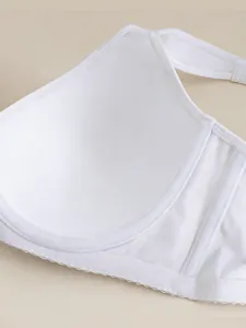 Close-up of thin white bra cup with smooth fabric and wide non-slip side wings