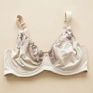 Elegant beige plus size bra with delicate floral lace embroidery and underwire support.