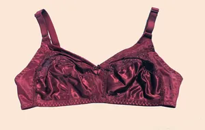 Close-up detail of a wine red wireless lace bra with smooth satin finish and bow