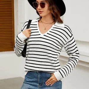 Model wearing a stylish black and white striped long sleeve V-neck knit sweater outdoors