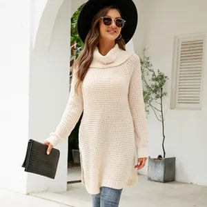 Full-length view of a beige waffle-knit oversized sweater dress with side slits on a model
